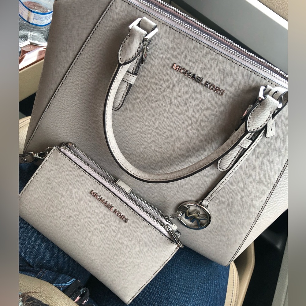 A Michael Kors handbag and matching wallet.